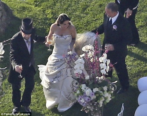 Alexis also wore a dramatic long veil and carried a bouquet of purple and white roses